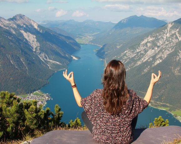 bigstock-Young-Woman-Meditating-At-Moun-73469740-580x460.jpg